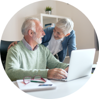An elderly couple looking at laptop